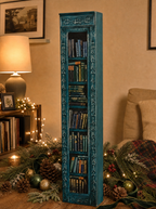 Midwinter Teal mini book advent calendar, closed, in a cozy living room